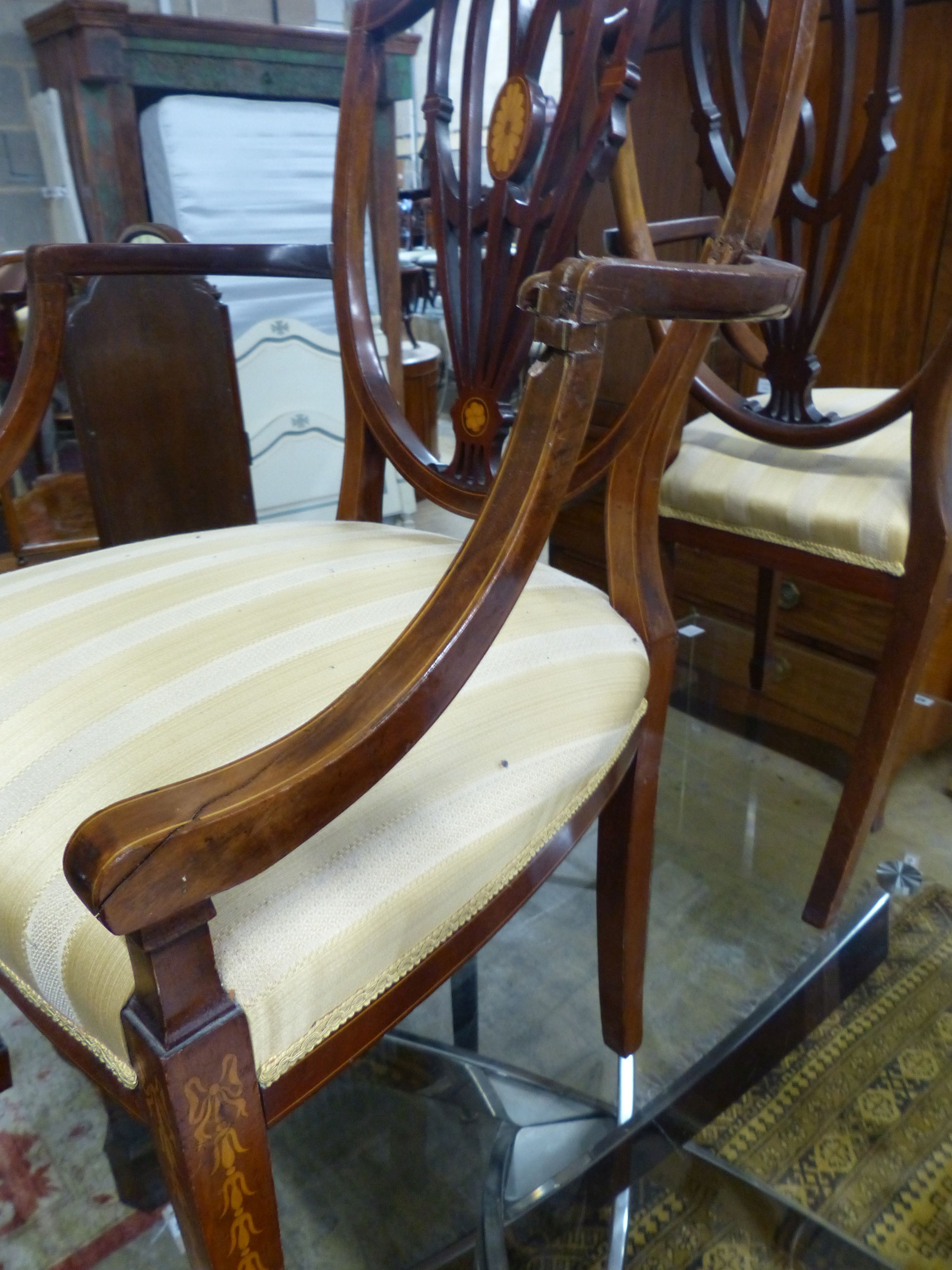 A pair of Edwardian Sheraton revival inlaid mahogany shield back elbow chairs (one a.f.)